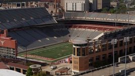 5.7K aerial stock footage ascend to focus on the empty football stadium at the University of Texas, Austin, Texas Aerial Stock Footage | DX0002_108_025