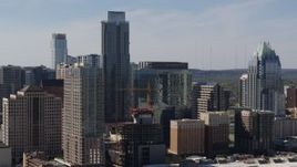 5.7K aerial stock footage focus on The Austonian skyscraper and high-rise hotel during ascent in Downtown Austin, Texas Aerial Stock Footage | DX0002_108_031