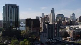 5.7K aerial stock footage of flying by a high-rise with a view of the city's skyline in Downtown Austin, Texas Aerial Stock Footage | DX0002_108_046