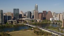 5.7K aerial stock footage of the city's skyline across Lady Bird Lake, ascend near bridge, Downtown Austin, Texas Aerial Stock Footage | DX0002_109_001