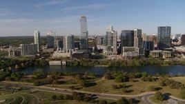 5.7K aerial stock footage of tall skyscrapers in the city's waterfront skyline across Lady Bird Lake, Downtown Austin, Texas Aerial Stock Footage | DX0002_109_017