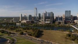 5.7K aerial stock footage of a view of tall skyscrapers in the city's waterfront skyline across Lady Bird Lake, Downtown Austin, Texas Aerial Stock Footage | DX0002_109_018