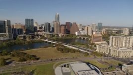 5.7K aerial stock footage a reverse view of the city's waterfront skyline and First Street Bridge over Lady Bird Lake, Downtown Austin, Texas Aerial Stock Footage | DX0002_109_023