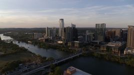 5.7K aerial stock footage reverse view of the city's waterfront skyline and Lady Bird Lake at sunset in Downtown Austin, Texas Aerial Stock Footage | DX0002_110_003