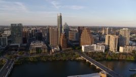 5.7K aerial stock footage of waterfront skyscrapers across Lady Bird Lake at sunset in Downtown Austin, Texas Aerial Stock Footage | DX0002_110_004