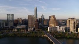 5.7K aerial stock footage of a view of waterfront skyscrapers across Lady Bird Lake at sunset in Downtown Austin, Texas Aerial Stock Footage | DX0002_110_006
