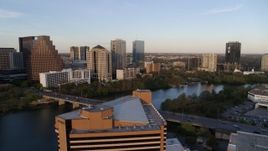 5.7K aerial stock footage fly over hotel toward waterfront skyscrapers and Lady Bird Lake at sunset, Downtown Austin, Texas Aerial Stock Footage | DX0002_110_008