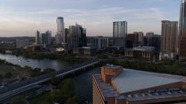 5.7K aerial stock footage fly away from skyline and Lady Bird Lake at sunset, reveal hotel in Downtown Austin, Texas Aerial Stock Footage | DX0002_110_009