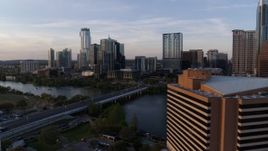 5.7K aerial stock footage flyby hotel to approach skyline and Lady Bird Lake at sunset, Downtown Austin, Texas Aerial Stock Footage | DX0002_110_010