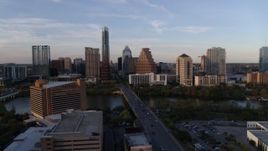 5.7K aerial stock footage of skyline across bridge and Lady Bird Lake at sunset in Downtown Austin, Texas Aerial Stock Footage | DX0002_110_013