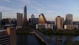 5.7K aerial stock footage approach bridge and skyline across Lady Bird Lake at sunset in Downtown Austin, Texas Aerial Stock Footage | DX0002_110_014