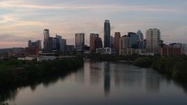 5.7K aerial stock footage of the city's skyline seen from low over Lady Bird Lake at sunset in Downtown Austin, Texas Aerial Stock Footage | DX0002_110_016