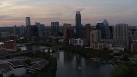 5.7K aerial stock footage of a reverse view of the skyline from over Lady Bird Lake at sunset in Downtown Austin, Texas Aerial Stock Footage | DX0002_110_018
