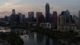 5.7K aerial stock footage of a slow approach to the waterfront skyline from Lady Bird Lake at sunset in Downtown Austin, Texas Aerial Stock Footage | DX0002_110_022