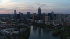 5.7K aerial stock footage slowly fly away from city skyline by Lady Bird Lake at twilight in Downtown Austin, Texas Aerial Stock Footage | DX0002_110_024
