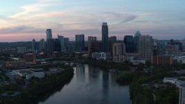 5.7K aerial stock footage of the city skyline by Lady Bird Lake at twilight in Downtown Austin, Texas Aerial Stock Footage | DX0002_110_025