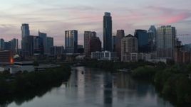 5.7K aerial stock footage slowly approaching city skyline by Lady Bird Lake at twilight in Downtown Austin, Texas Aerial Stock Footage | DX0002_110_026
