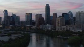5.7K aerial stock footage a stationary view of city skyline by Lady Bird Lake at twilight in Downtown Austin, Texas Aerial Stock Footage | DX0002_110_027