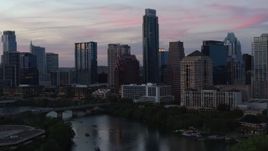 5.7K aerial stock footage focus on The Austonian in city skyline during allow approach from Lady Bird Lake at twilight in Downtown Austin, Texas Aerial Stock Footage | DX0002_110_028