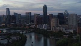 5.7K aerial stock footage of The Austonian and city skyline seen from Lady Bird Lake at twilight in Downtown Austin, Texas Aerial Stock Footage | DX0002_110_031