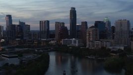 5.7K aerial stock footage of tall Austonian and city skyline seen during pass over Lady Bird Lake at twilight in Downtown Austin, Texas Aerial Stock Footage | DX0002_110_034