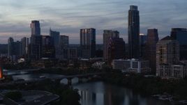 5.7K aerial stock footage approach bridge and city skyline from Lady Bird Lake at twilight in Downtown Austin, Texas Aerial Stock Footage | DX0002_110_035