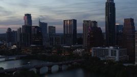 5.7K aerial stock footage approach bridge and skyscrapers by Lady Bird Lake at twilight in Downtown Austin, Texas Aerial Stock Footage | DX0002_110_036