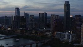 5.7K aerial stock footage reverse view of skyscrapers by Lady Bird Lake and bridge at twilight in Downtown Austin, Texas Aerial Stock Footage | DX0002_110_037