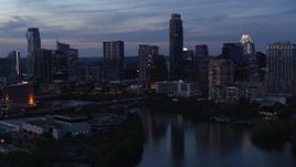 5.7K aerial stock footage pan across skyline by Lady Bird Lake and bridge at twilight in Downtown Austin, Texas Aerial Stock Footage | DX0002_110_039