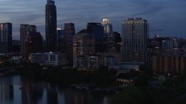 5.7K aerial stock footage approach San Jacinto Center beside Lady Bird Lake at twilight in Downtown Austin, Texas Aerial Stock Footage | DX0002_110_040