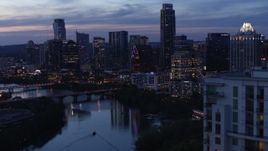 5.7K aerial stock footage pass over Lady Bird Lake, focus on Congress Avenue Bridge and skyline at twilight in Downtown Austin, Texas Aerial Stock Footage | DX0002_110_047
