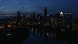 5.7K aerial stock footage follow Lady Bird Lake, focus on the waterfront skyline at twilight in Downtown Austin, Texas Aerial Stock Footage | DX0002_111_002