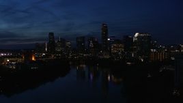 5.7K aerial stock footage slowly passing waterfront skyline on the shore of Lady Bird Lake at twilight in Downtown Austin, Texas Aerial Stock Footage | DX0002_111_009