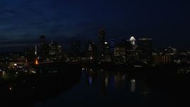 5.7K aerial stock footage slowly flyby city's waterfront skyline on the opposite shore of Lady Bird Lake at night in Downtown Austin, Texas Aerial Stock Footage | DX0002_111_013