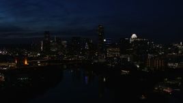 5.7K aerial stock footage slowly passing city's waterfront skyline on the opposite shore of Lady Bird Lake at night in Downtown Austin, Texas Aerial Stock Footage | DX0002_111_014