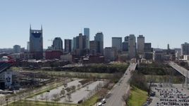 5.7K aerial stock footage ascend for view of city's skyline near the river in Downtown Nashville, Tennessee Aerial Stock Footage | DX0002_112_001