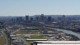 5.7K aerial stock footage a wide view of the city's skyline and river seen from warehouse buildings in Downtown Nashville, Tennessee Aerial Stock Footage | DX0002_112_015