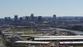 5.7K aerial stock footage a wide view of the city's skyline and river seen while passing warehouse buildings in Downtown Nashville, Tennessee Aerial Stock Footage | DX0002_112_018