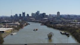 5.7K aerial stock footage a wide view of the city's skyline a barge sails the river in Downtown Nashville, Tennessee Aerial Stock Footage | DX0002_112_020