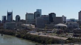 5.7K aerial stock footage of the city's skyline while flying by the Cumberland River, Downtown Nashville, Tennessee Aerial Stock Footage | DX0002_112_031