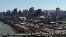 5.7K aerial stock footage the city skyline seen from bridge spanning the river, Downtown Nashville, Tennessee Aerial Stock Footage | DX0002_113_004