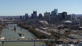 5.7K aerial stock footage the city skyline while flying by traffic on bridge over the river, Downtown Nashville, Tennessee Aerial Stock Footage | DX0002_113_007