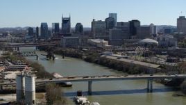 5.7K aerial stock footage of skyscrapers in the city's skyline, seen from a bridge over the river, Downtown Nashville, Tennessee Aerial Stock Footage | DX0002_113_012
