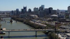 5.7K aerial stock footage flyby bridge over the river, focus on city's skyline Downtown Nashville, Tennessee Aerial Stock Footage | DX0002_113_013
