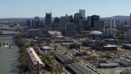 5.7K aerial stock footage of the city's riverfront skyline, seen while ascending by the river, Downtown Nashville, Tennessee Aerial Stock Footage | DX0002_113_014
