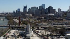 5.7K aerial stock footage descend near bridge with heavy traffic, focus on city's skyline Downtown Nashville, Tennessee Aerial Stock Footage | DX0002_113_015