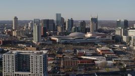 5.7K aerial stock footage of a reverse view of the convention center and skyline in Downtown Nashville, Tennessee Aerial Stock Footage | DX0002_114_018