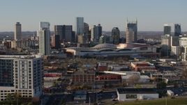 5.7K aerial stock footage ascend over freeway toward the city skyline behind the convention center, in Downtown Nashville, Tennessee Aerial Stock Footage | DX0002_114_023