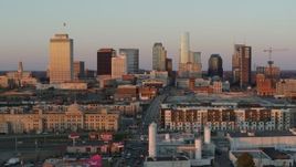 5.7K aerial stock footage of a reverse view of the city's skyline at sunset in Downtown Nashville, Tennessee Aerial Stock Footage | DX0002_115_004