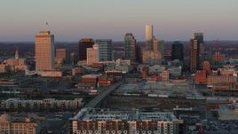 5.7K aerial stock footage of passing by the city's skyline at sunset in Downtown Nashville, Tennessee Aerial Stock Footage | DX0002_115_007